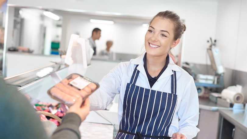 woman-selling-sausages-in-store.jpg